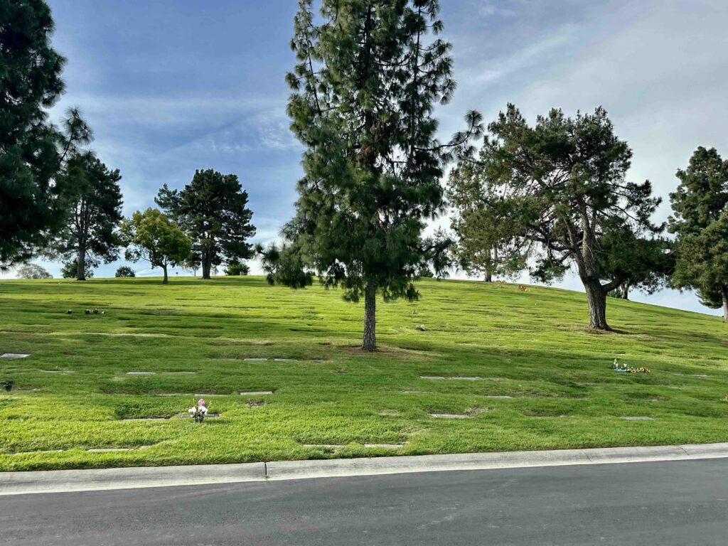 View across Inspiration lawn with trees and grass at Forest Lawn Memorial Park Covina - Bayer Cemetery Brokers