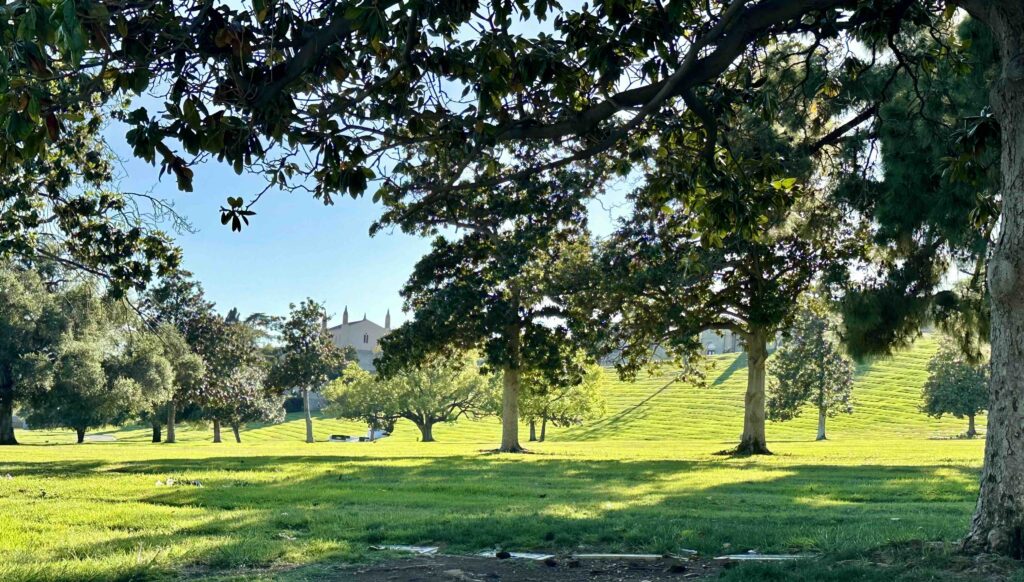 View of Vale of Memory towards Great Mausoleum from under shady trees at Forest Lawn Memorial Park Glendale - Bayer Cemetery Brokers