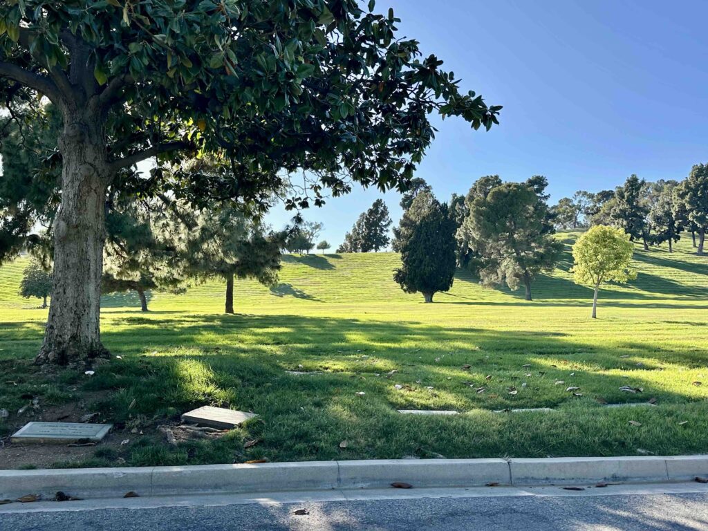View of Vale of Memory with shady trees and grass at Forest Lawn Memorial Park Glendale - Bayer Cemetery Brokers