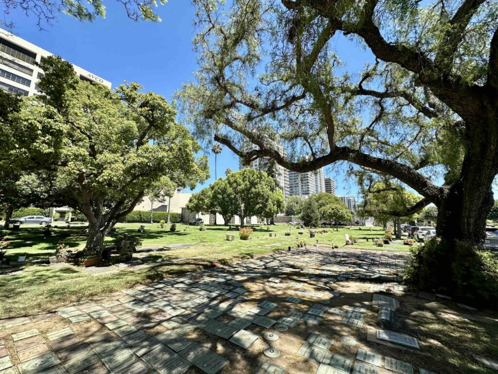 View over the peaceful urn garden beneath mature shady trees at Pierce Brothers Westwood Village Memorial Park- Bayer Cemetery Brokers