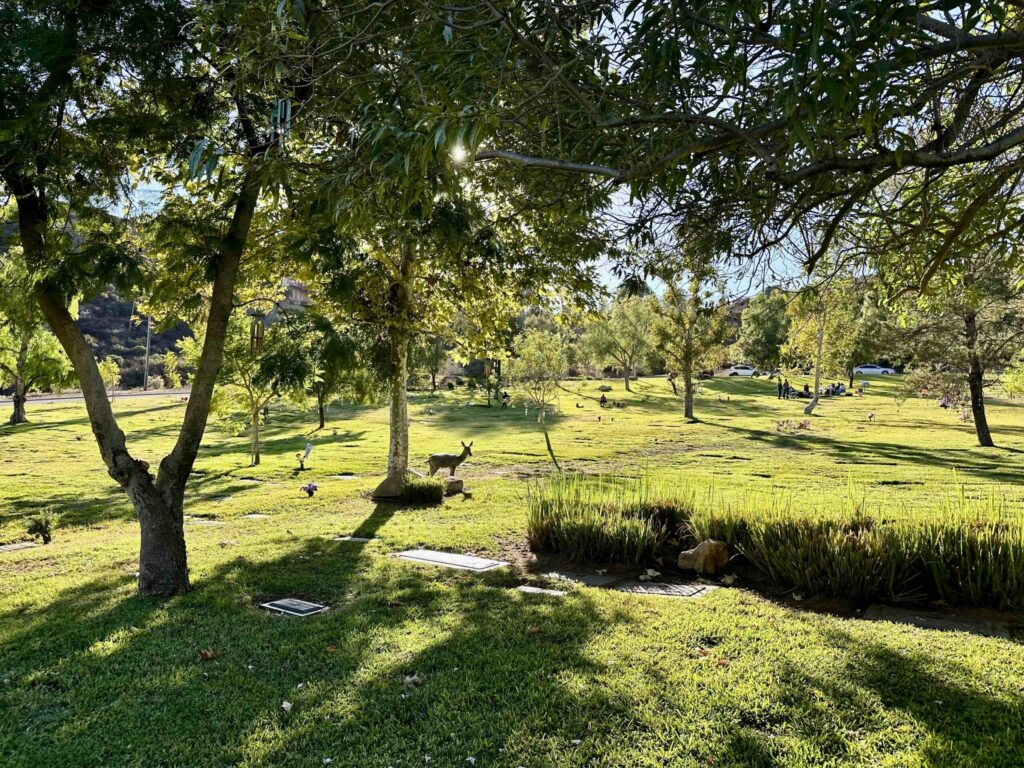 View of Staggs Retreat statue in Garden of Devotion with shady trees and beautiful landscaping at Singing Hills Memorial Park in El Cajon- Bayer Cemetery Brokers