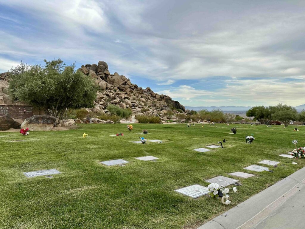 Serene and peaceful view across the Eternal Rocks section with spectacular desert and hills in the distance at Sunset Hills Memorial Park Apple Valley - Bayer Cemetery Brokers